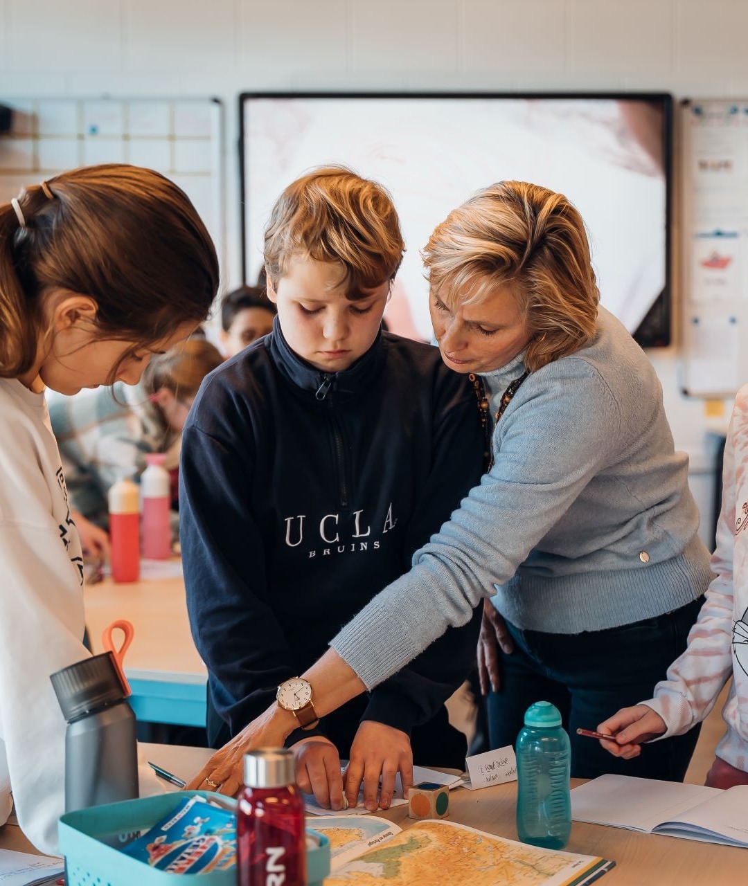 juf Iris begeleidt leerlingen bij het maken van opdrachten uit het doeboek